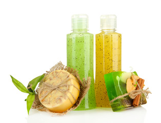 Bottles with scrub and hand-made soap, isolated on white