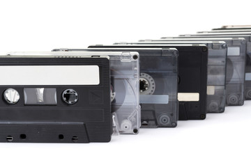 row of audio tapes isolated on white background