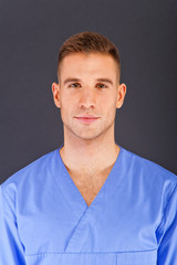Obraz premium Doctor over dark background in blue shirt