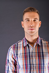 Man overdark background in squared shirt