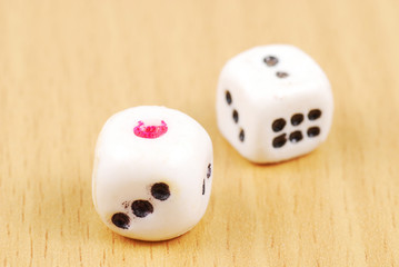 Dice close up on a wood  background.