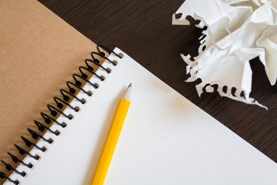 Notebook with a pencil and crumpled sheets of paper