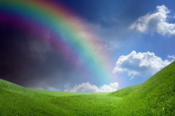 Obraz na płótnie Canvas Rainbow over green hills