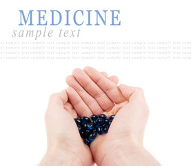 Pills in hands isolated on white