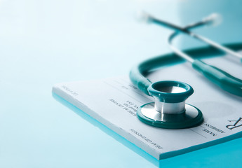 Empty medical prescription with a stethoscope on blue