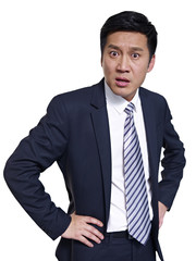 studio portrait of asian businessman, arms akimbo