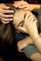 Young woman crying held and comforted by mother love problems