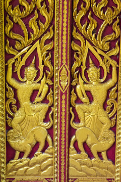 Ornament wooden door of Thai temple in Chiangmai, Thailand