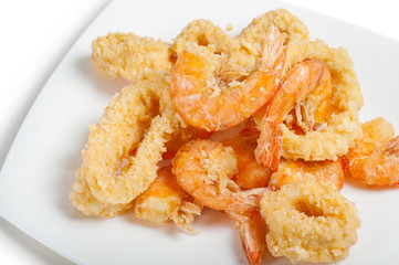 plate of fried fish on white background