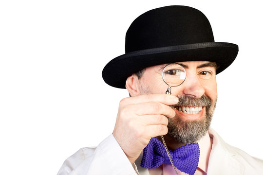 Portrait of happy middle-aged man in a hat with a monocle in his