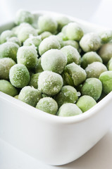 frozen peas close up in white background
