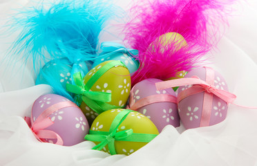 Beautiful easter eggs and decorative feathers, close up