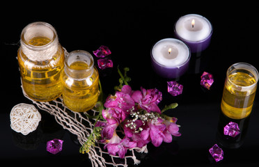 Spa oil and freesia isolated on black