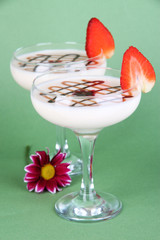 Fruit smoothies on green background