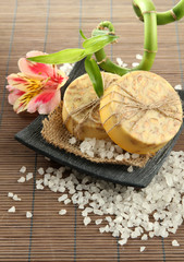 Hand-made soap and sea salt  on grey bamboo mat