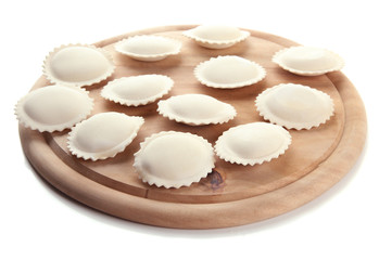 Raw dumplings on wooden desk, isolated on white