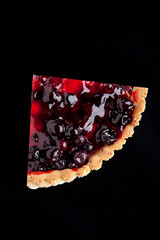 piece of berry pie isolated on black