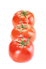 A group of three tomatoes on white background