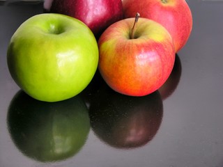 red and green apples on black table