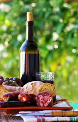 Meat, bread and wine on table