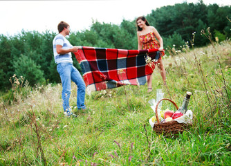 Happy young couple spending time together in park