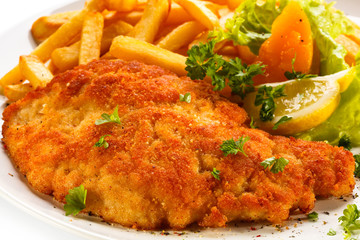 Pork chop, French fries and vegetables