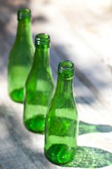 Three green empty bottles