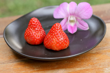 Strawberry in a black dish