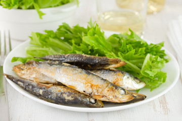 sardine with salad on white plate