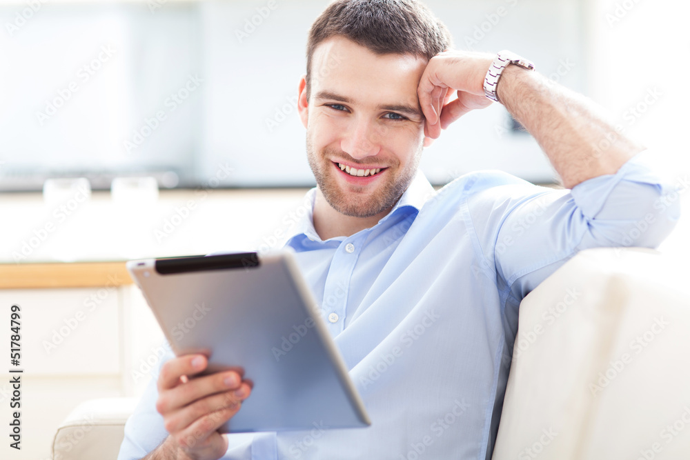 Wall mural man using digital tablet