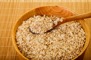 Bowl of Dried Oats in Wood Bowl