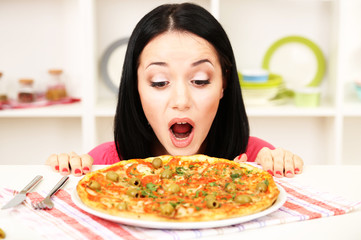 Beautiful girl wants to eat delicious pizza