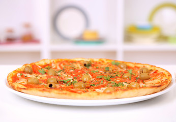 Tasty pizza on plate on kitchen background