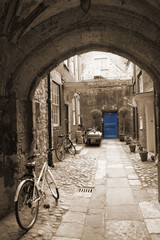 Back alley in London, with bikes, blue door at the end
