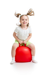 happy child jumping on bouncing ball. Isolated on white