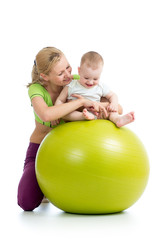 Fototapeta na wymiar mother and baby having fun with gymnastic ball