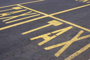 Yellow taxi street paintings on the asphalt