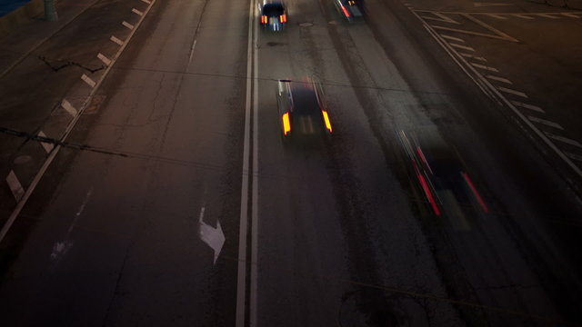 Car traffic at night. Time lapse with panning.