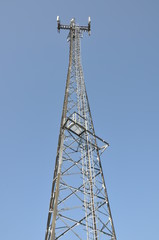 Telecommunication cell phone tower against blue sky