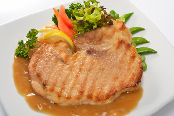 Grilled pork steak with vegetables and gravy sauce