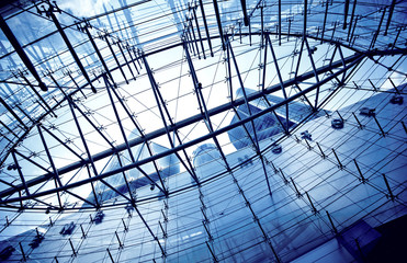 Bottom view on skyscrapers through the glass roof