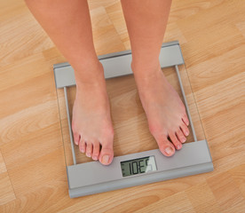 Low Section Of Woman Measuring Weight
