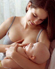 Obraz na płótnie Canvas mother feeding breast her daughter