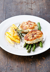 Fishcakes with french fries and asparagus