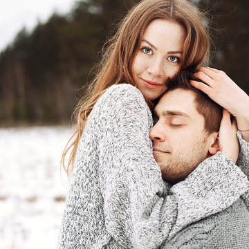 Outdoor happy couple in love posing in cold winter weather