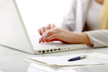 Close-up of businesswoman typing documents