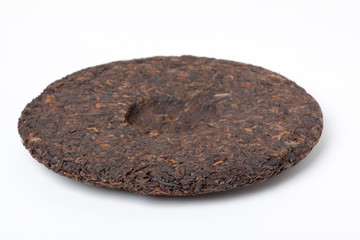 Disc of chinese puer tea isolated on a white background