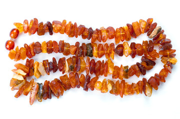 Beads of raw amber on white