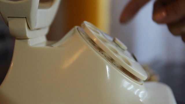Vintage classic white phone. Woman dials