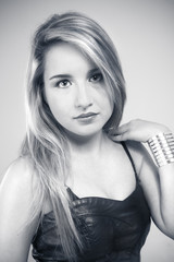 innocent and beautiful young blonde in black dress